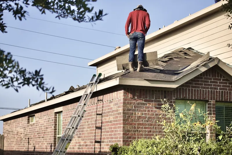 Professional roofer working on a residential roof in Lee Park
